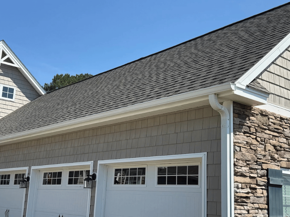 TwinAnchors_FeaturedImagesTwinAnchors_FeaturedImages_Gutters White gutters and downspout installed by Twin Anchors Roofing